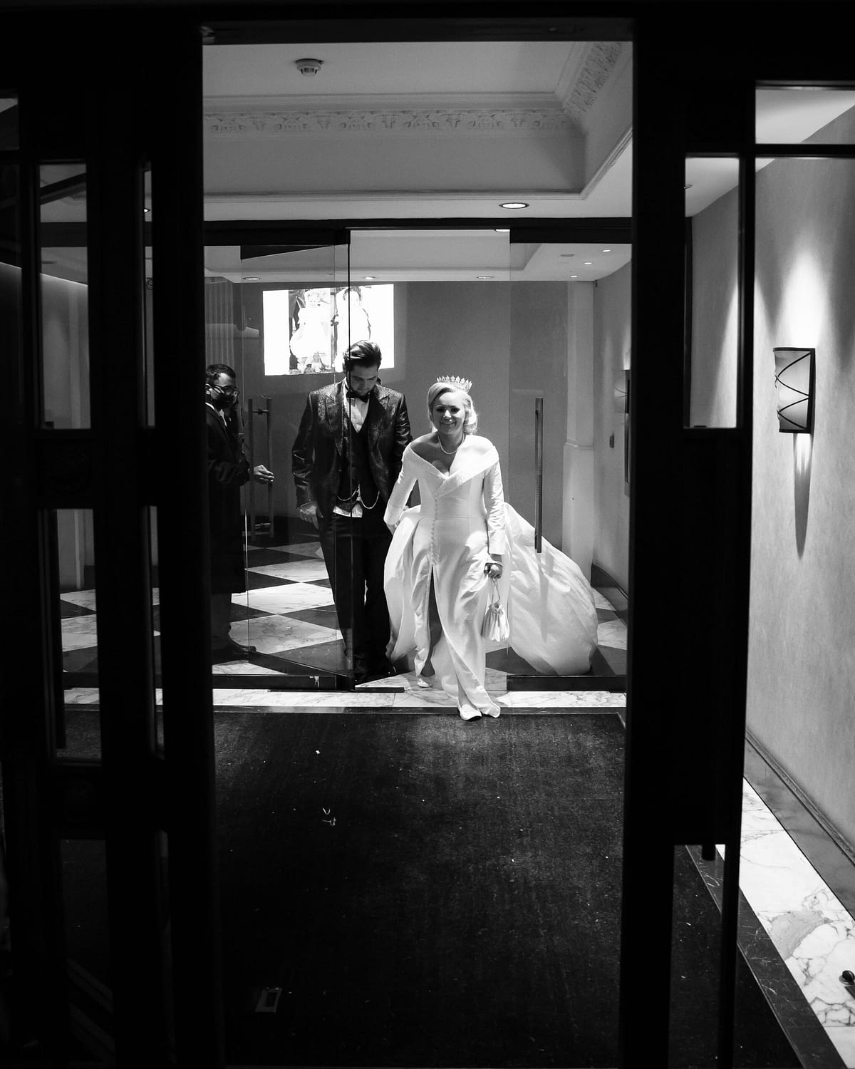 bride and groom walking out hotel door