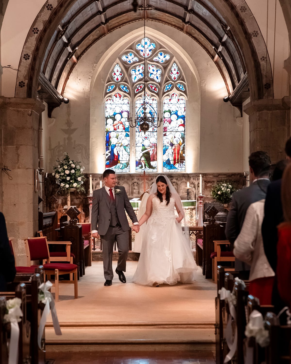 bride and groom walking together in church