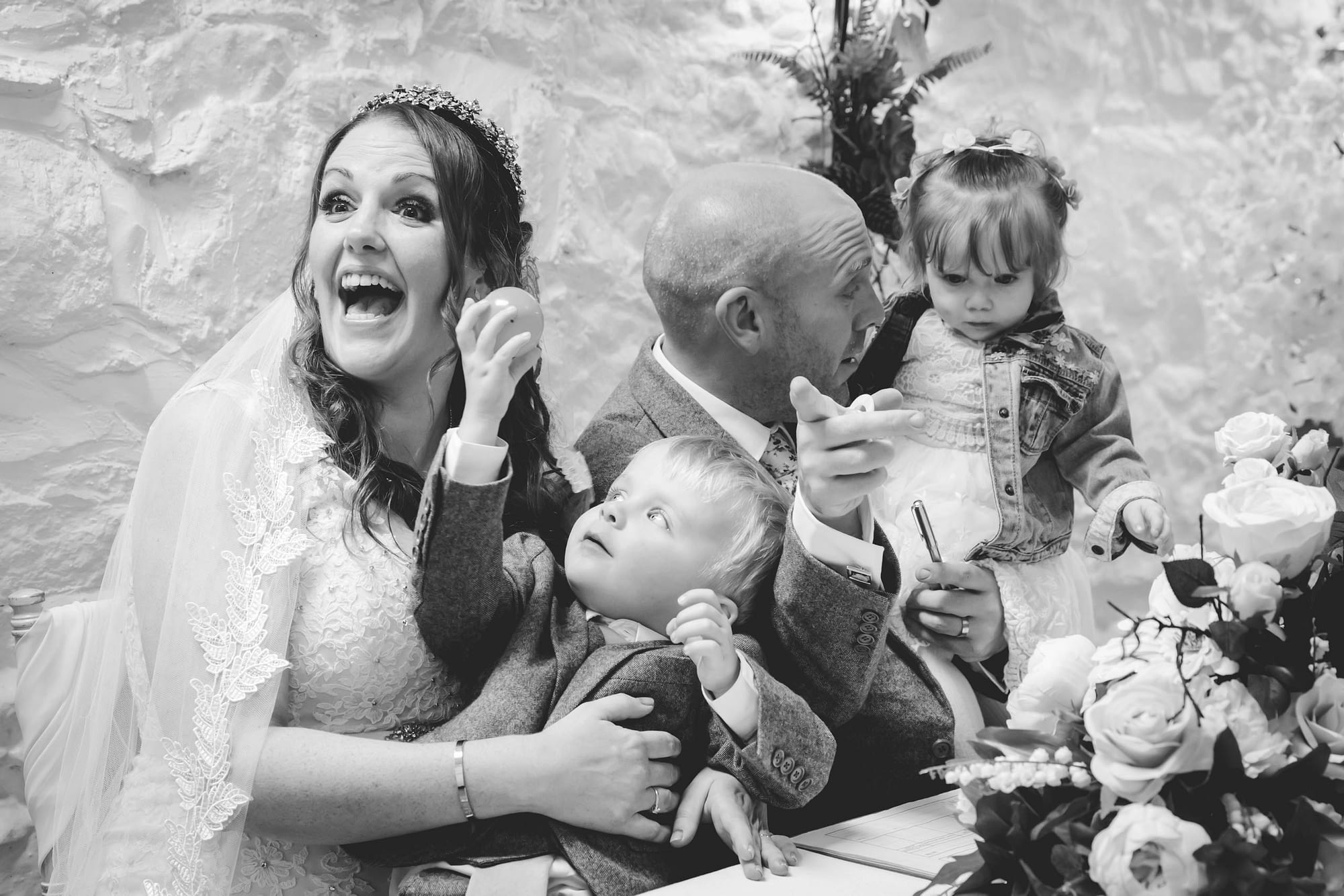 bride and groom with young children