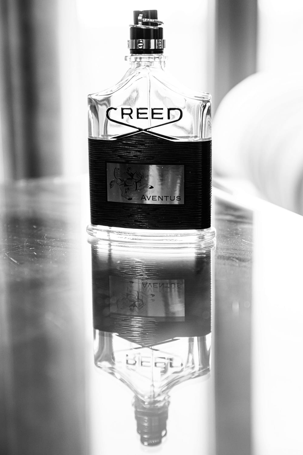 bottle of Creed aftershave on glass table