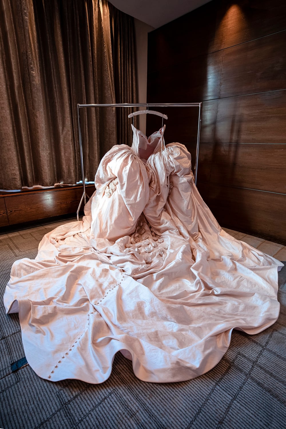 pink wedding dress hanging up inside